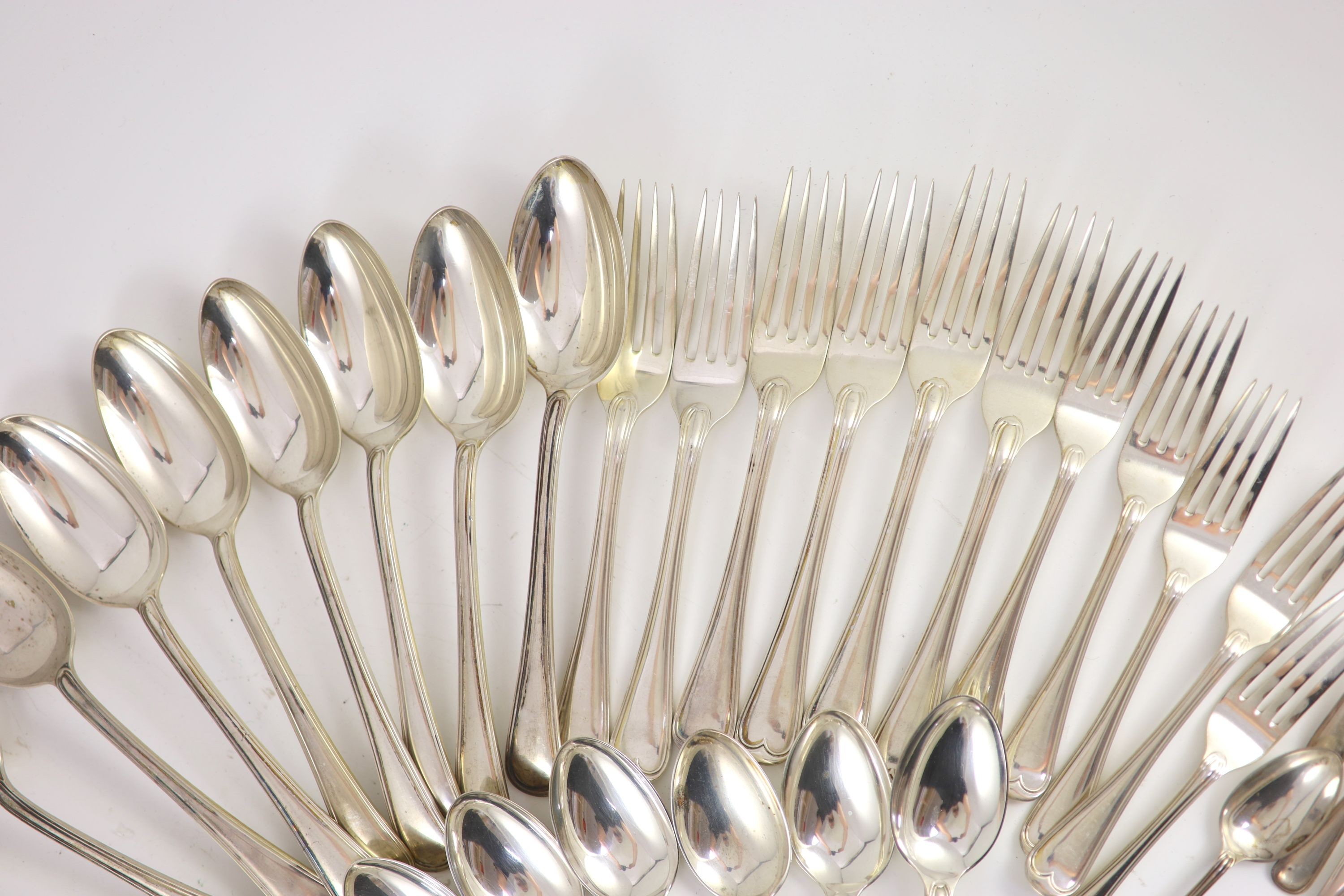 A part canteen of Edwardian silver Old English double struck thread pattern flatware for twelve by John Round & Son Ltd